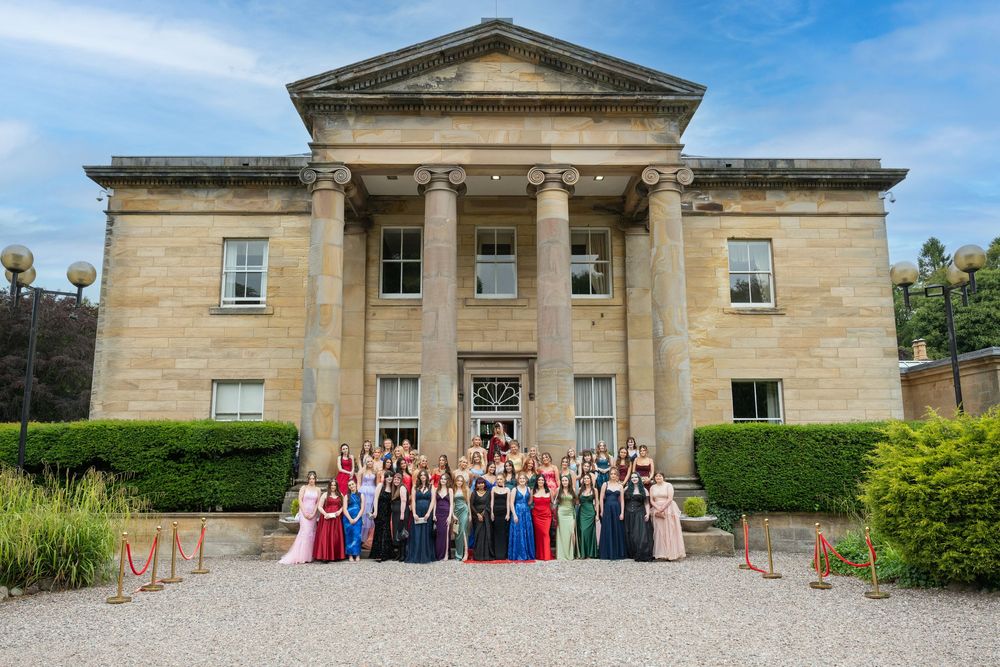 Balbirnie House exterior with formal group posed in front.