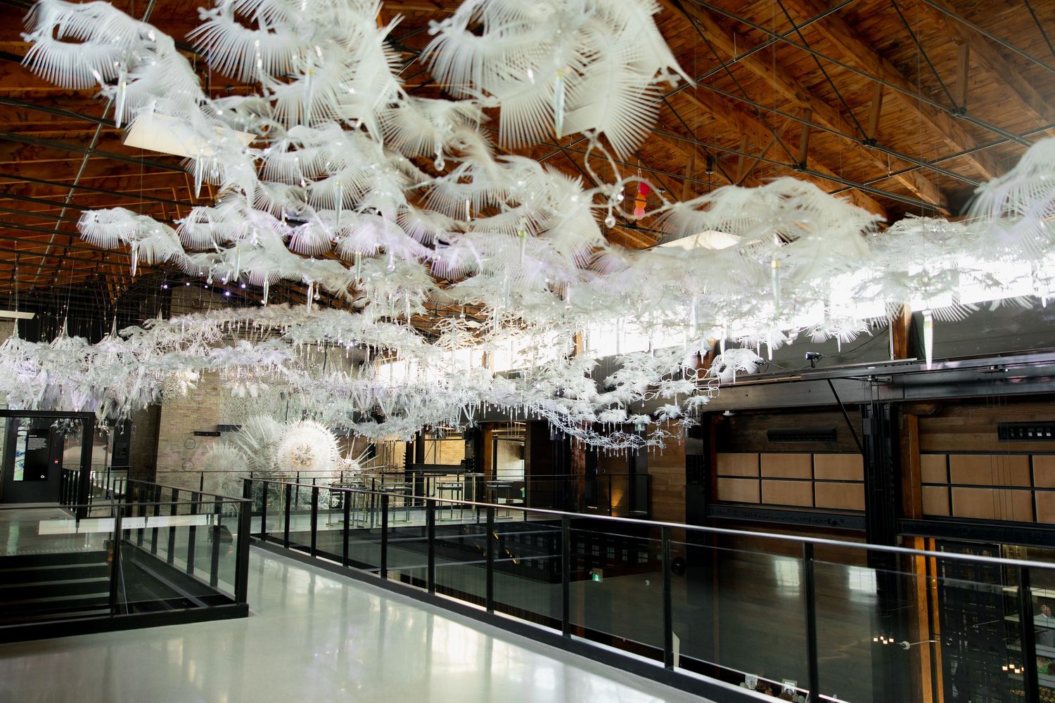 An elegant venue features dramatic white paper lanterns suspended from the ceiling.
