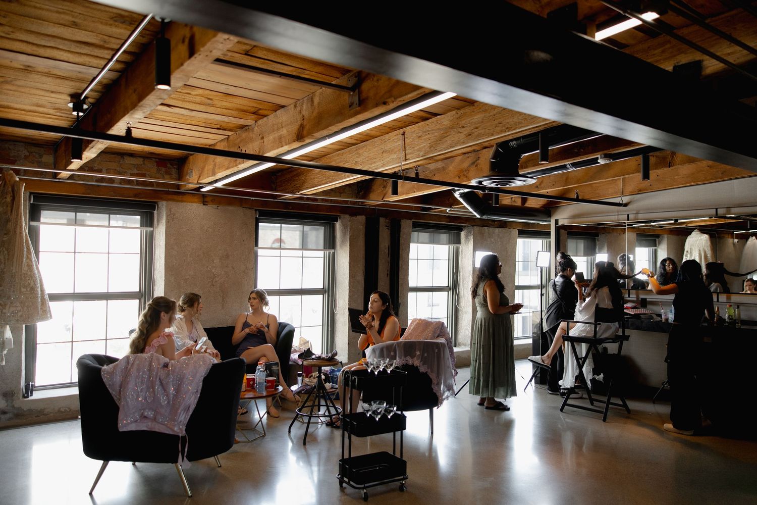 Industrial style event space with exposed ceiling beams and natural lighting.