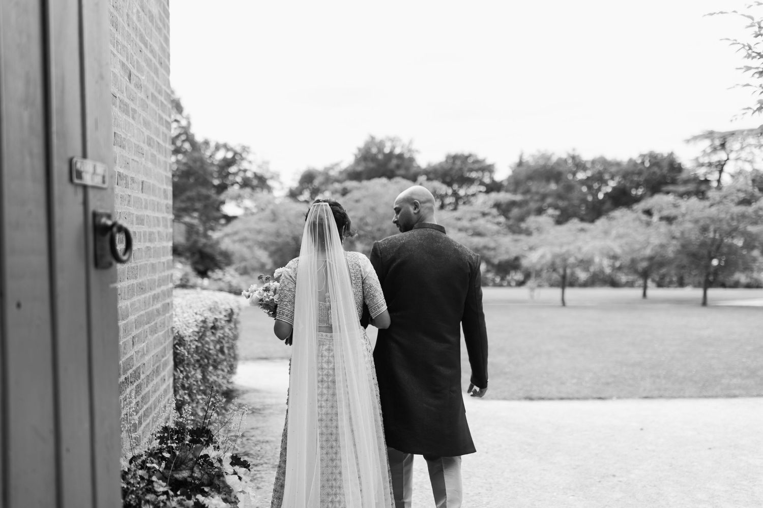 A black and white photo collage of a wedding couple walking together through various outdoor settings.