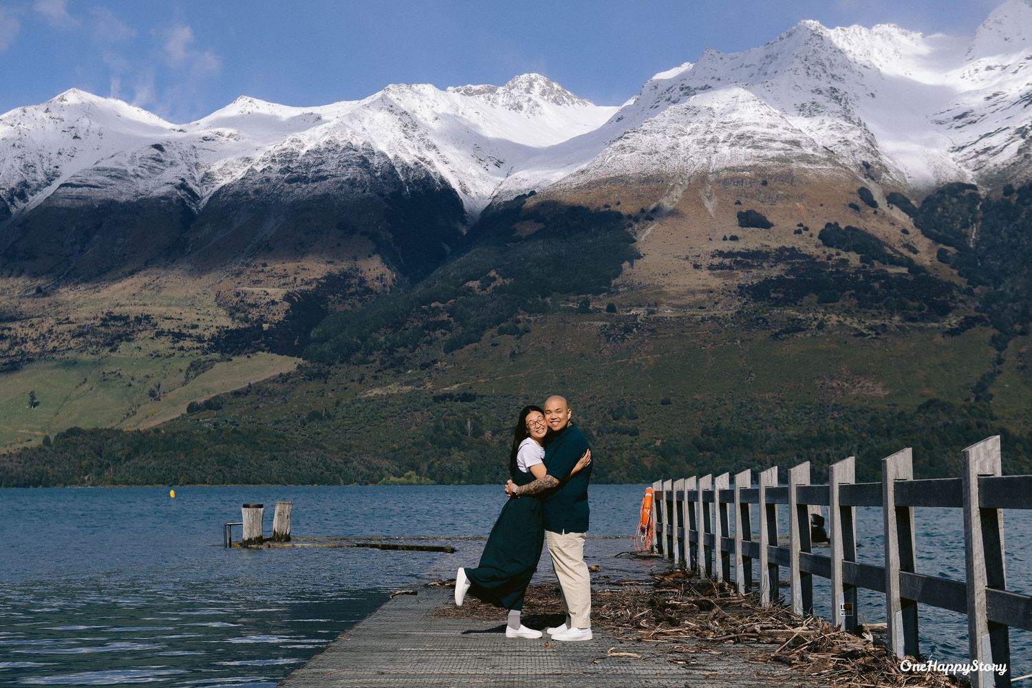 Romantic engagement photo of the couple surrounded by mountains in Glenorchy, New Zealand.