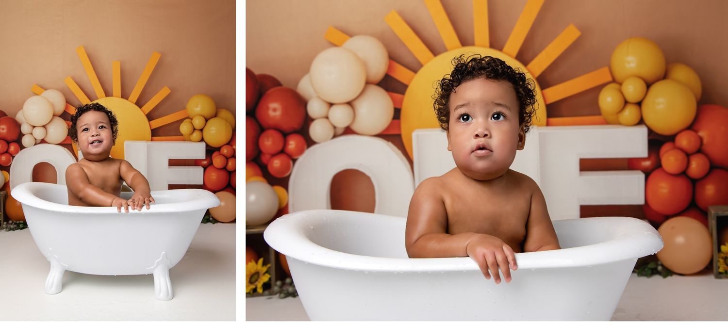 Baby sitting in white tub with colorful balloon backdrop during milestone session in Austin photography studio