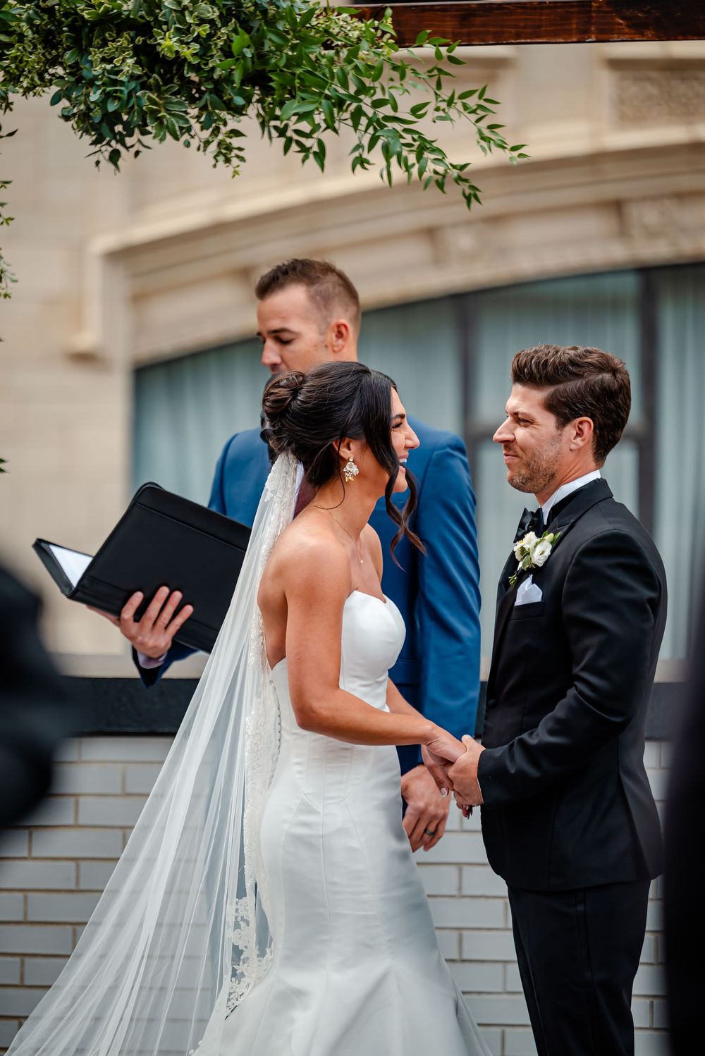 A sequence of wedding ceremony photos showing a couple sharing their first look and emotional reactions.