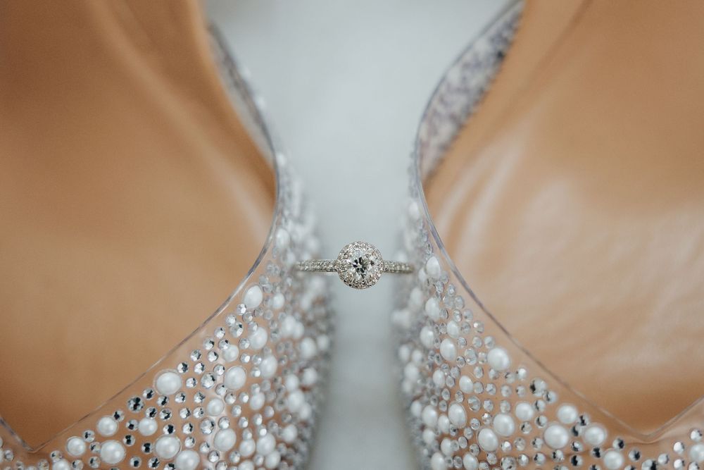 A close-up view of a delicate crystal beaded wedding dress bodice with intricate pearl and rhinestone details.