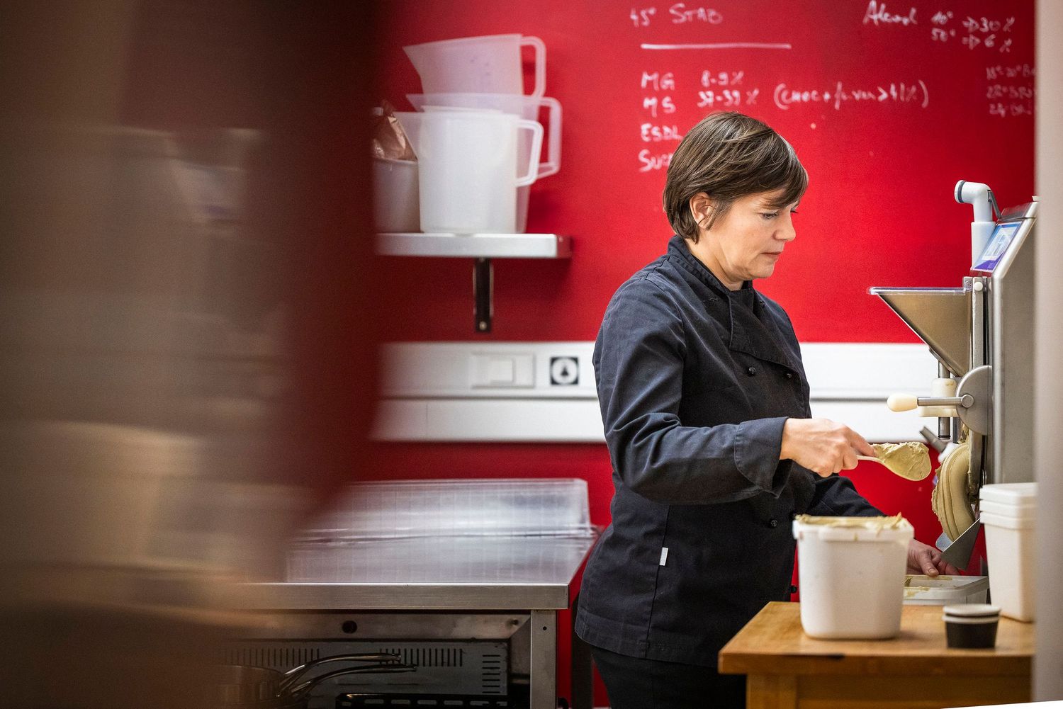 Interior cafe scene with red walls and white coffee cups.