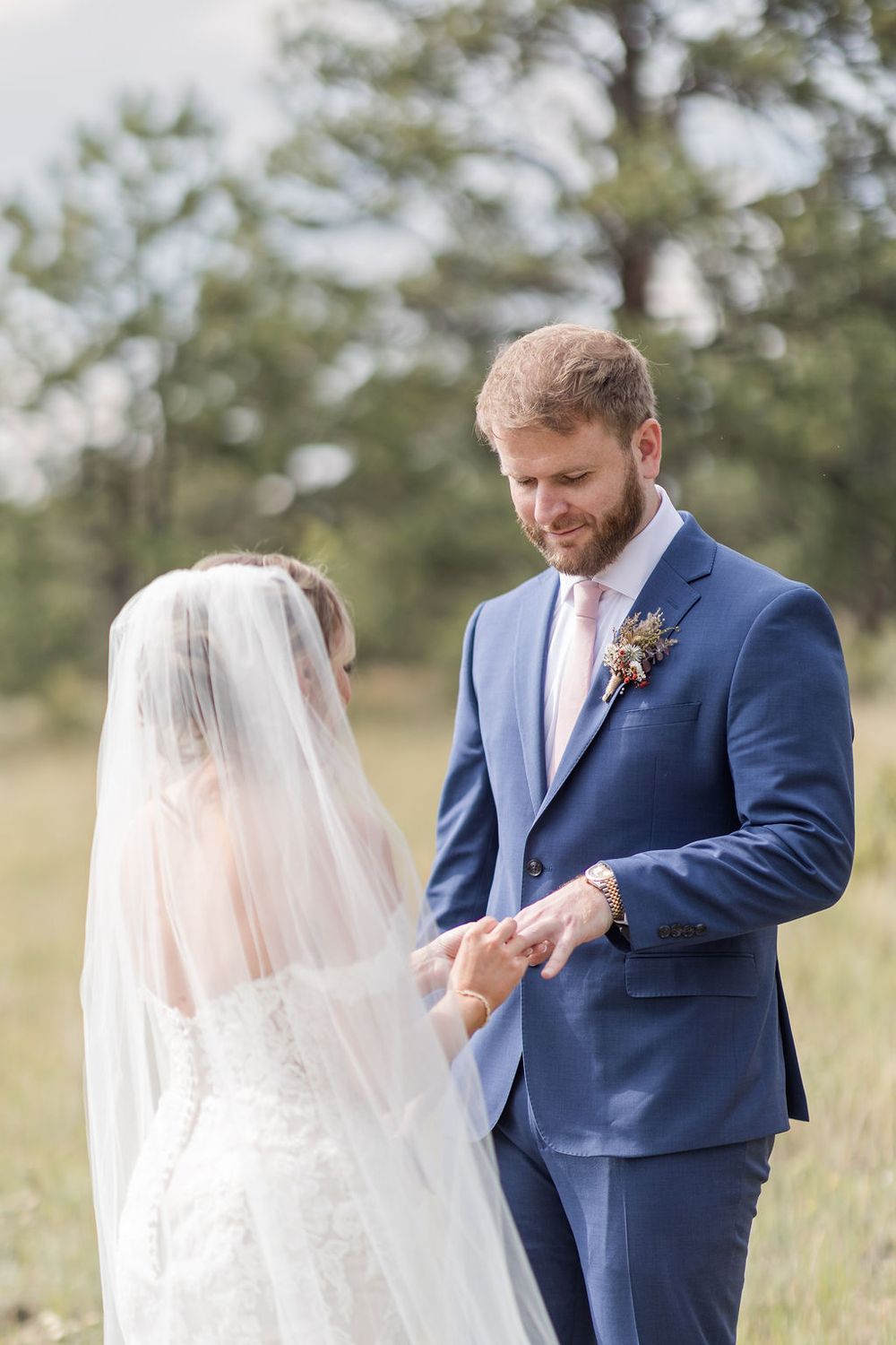 A series of romantic wedding photos showing a couple sharing intimate moments in a field.