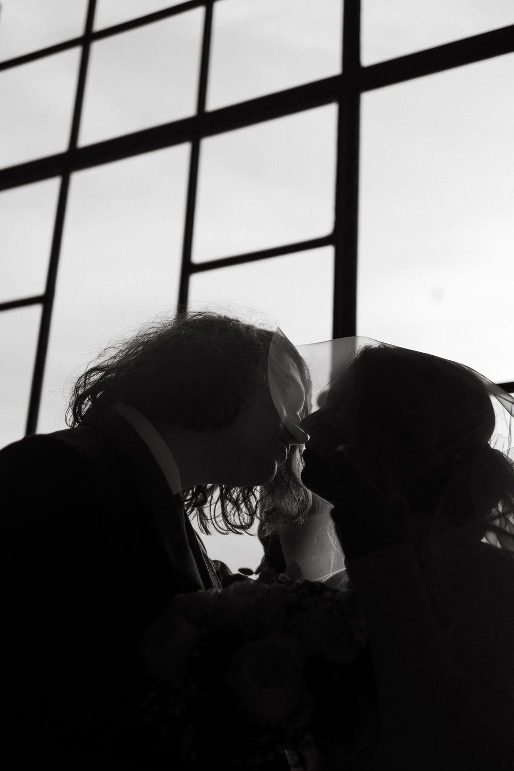 couple kissing during their winter wedding at Stockholm City Hall while being captured by Stockholm wedding photographer