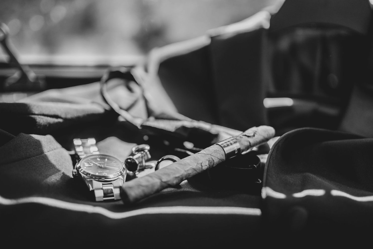 Close-up view of a vintage camera lens being adjusted in black and white photography.
