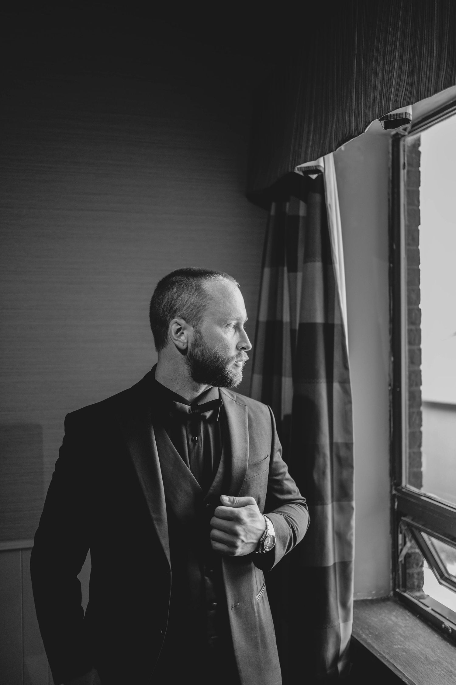Black and white photo sequence showing a groom looking pensively out a window in formal attire.