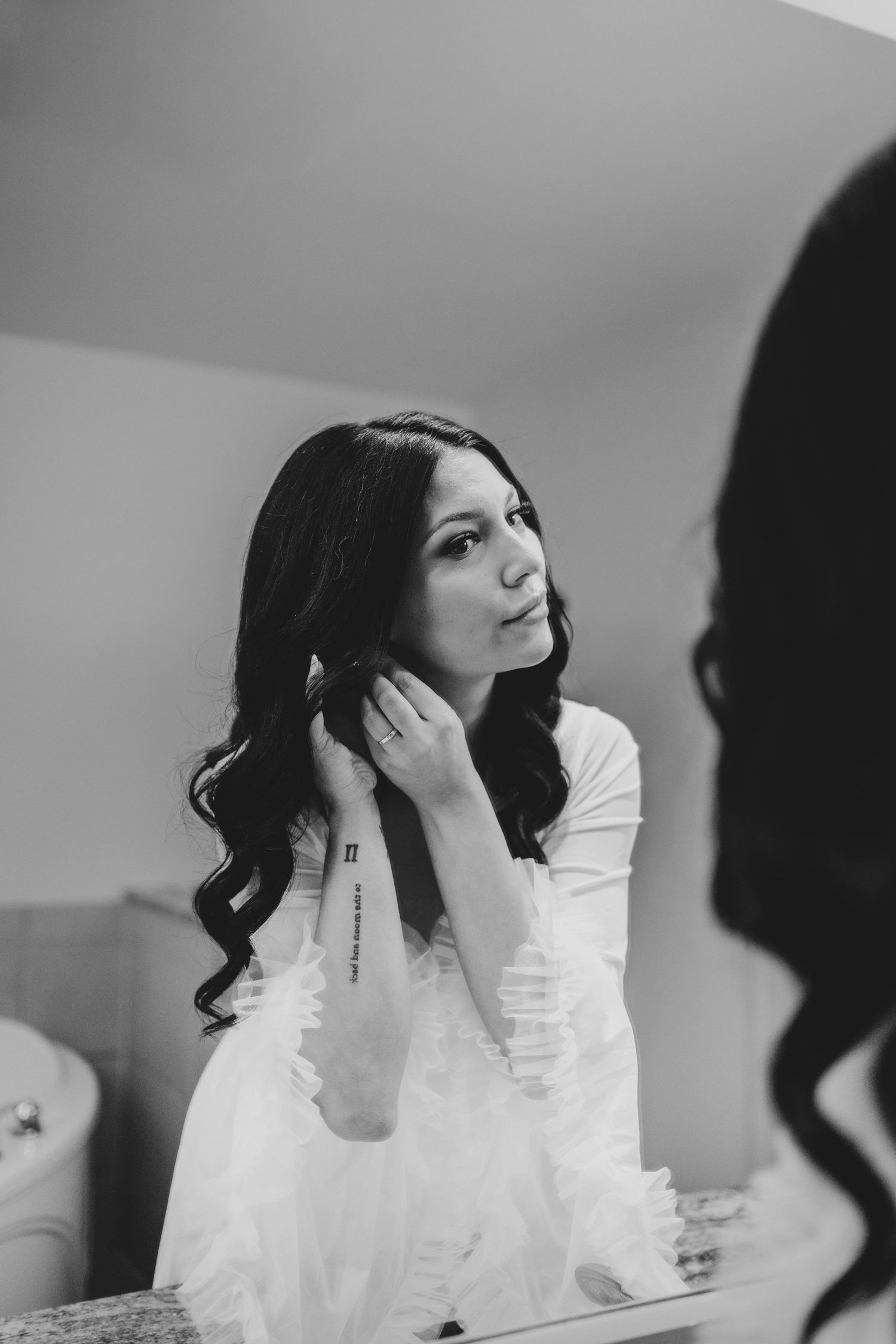 Series of black and white photos showing bride getting ready with dramatic lighting and expressions.