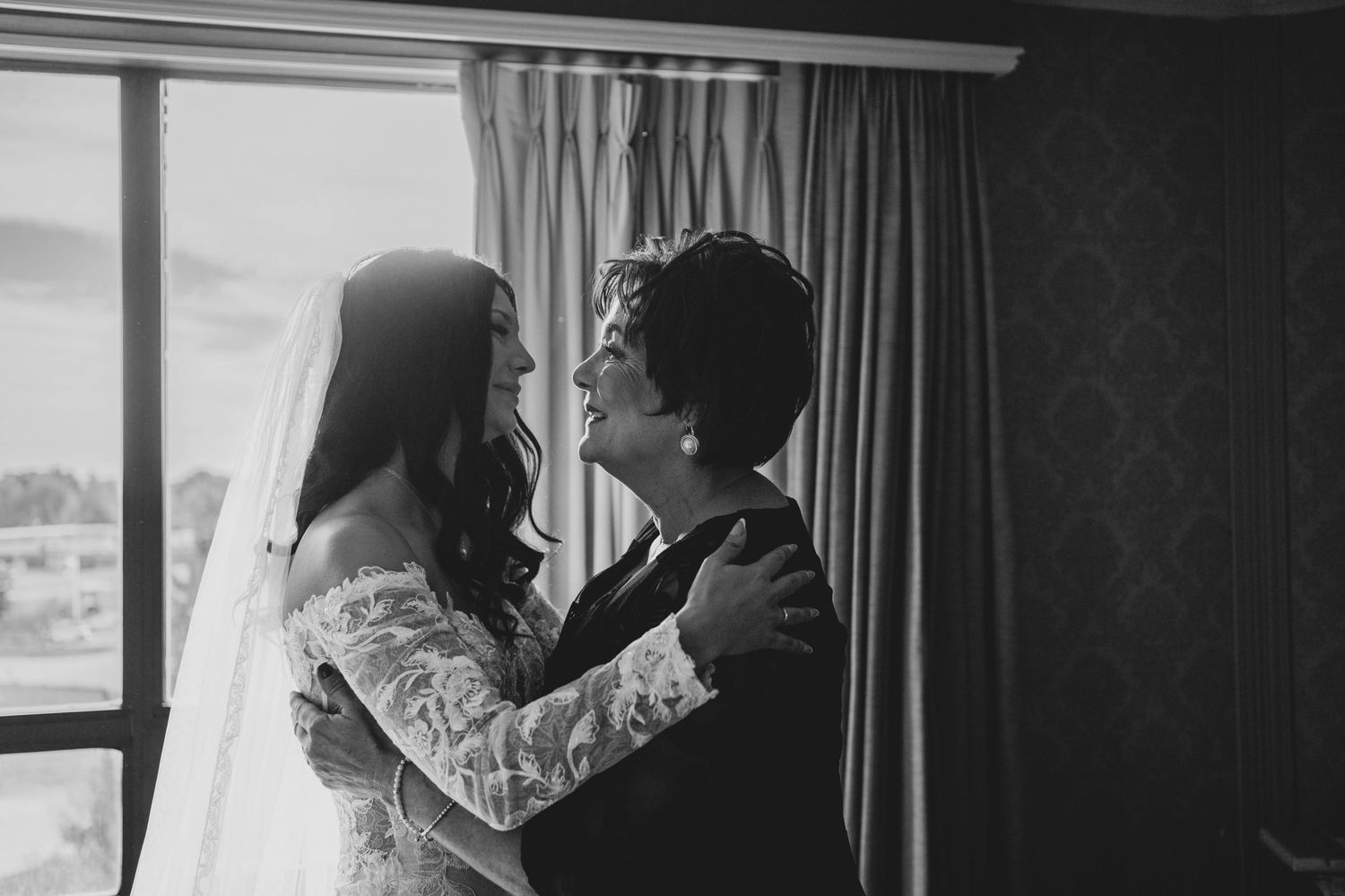 A black and white photo collage showing intimate moments of a couple on their wedding day.