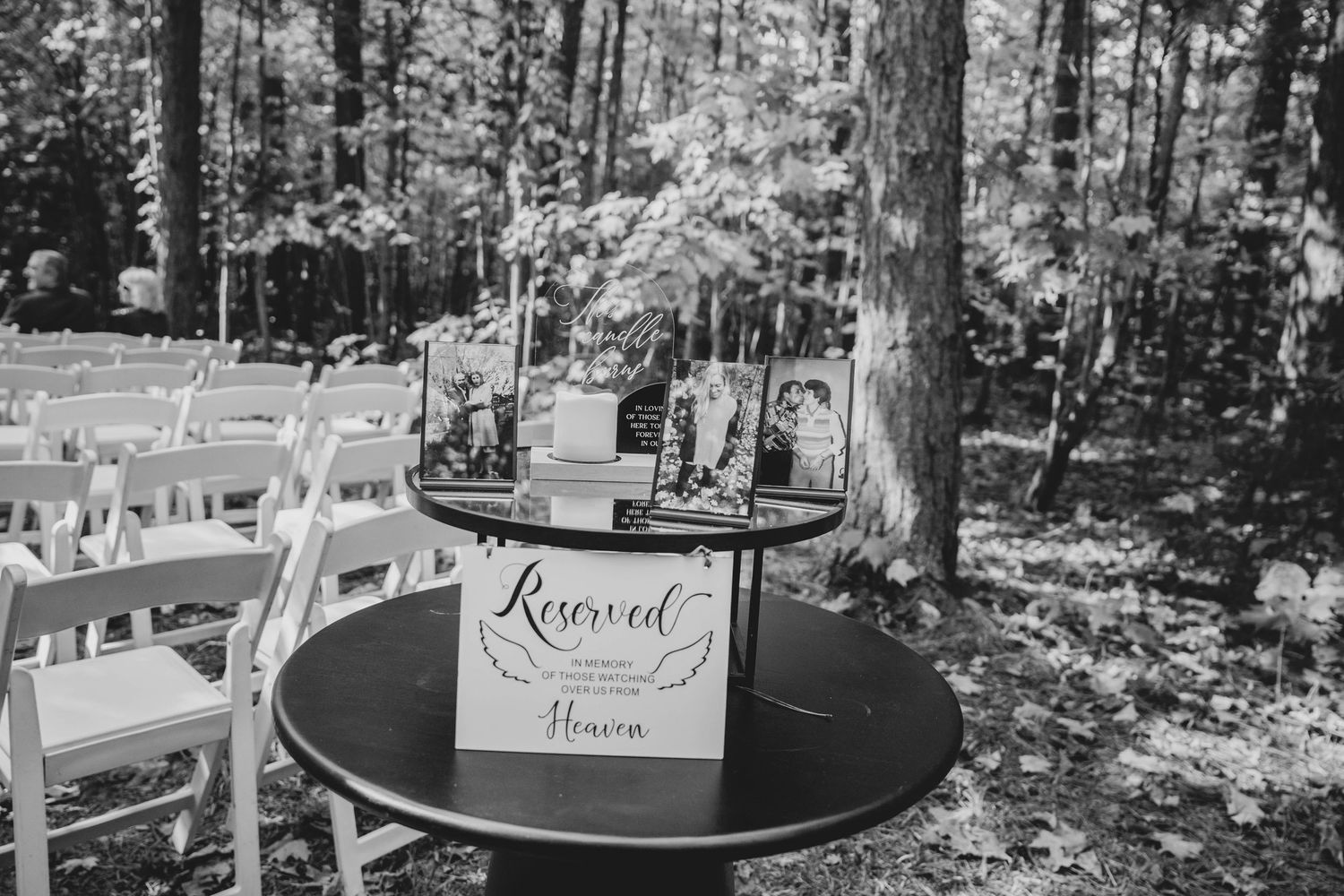 Rustic wooden wedding signs displayed in a wooded outdoor setting with natural forest backdrop.