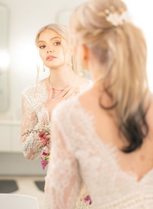 A soft, dreamy bridal portrait series with ethereal lighting and delicate lace details in a light-filled room.