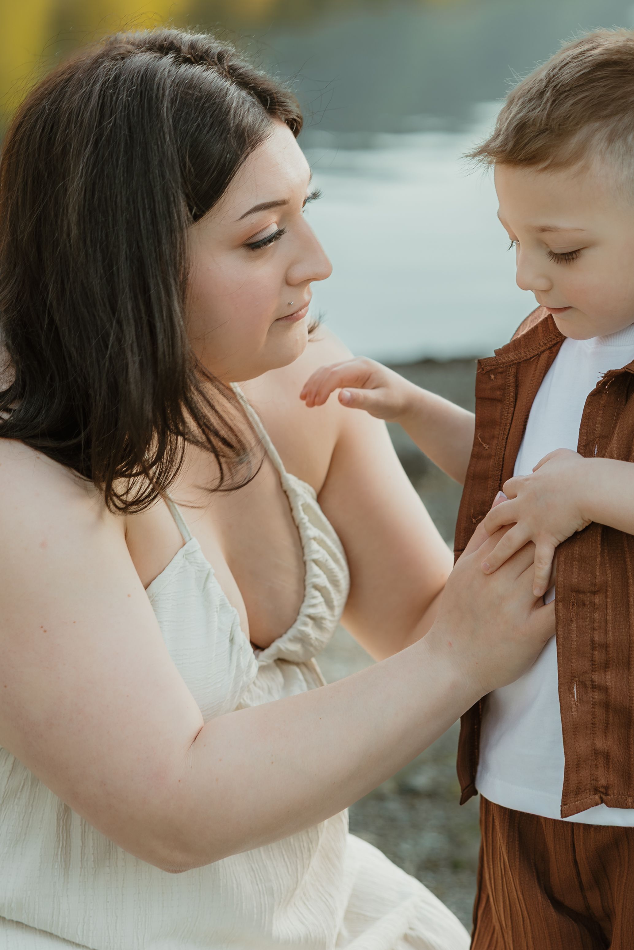 A tender moment between parent and child captured in a series of intimate poses by the water.