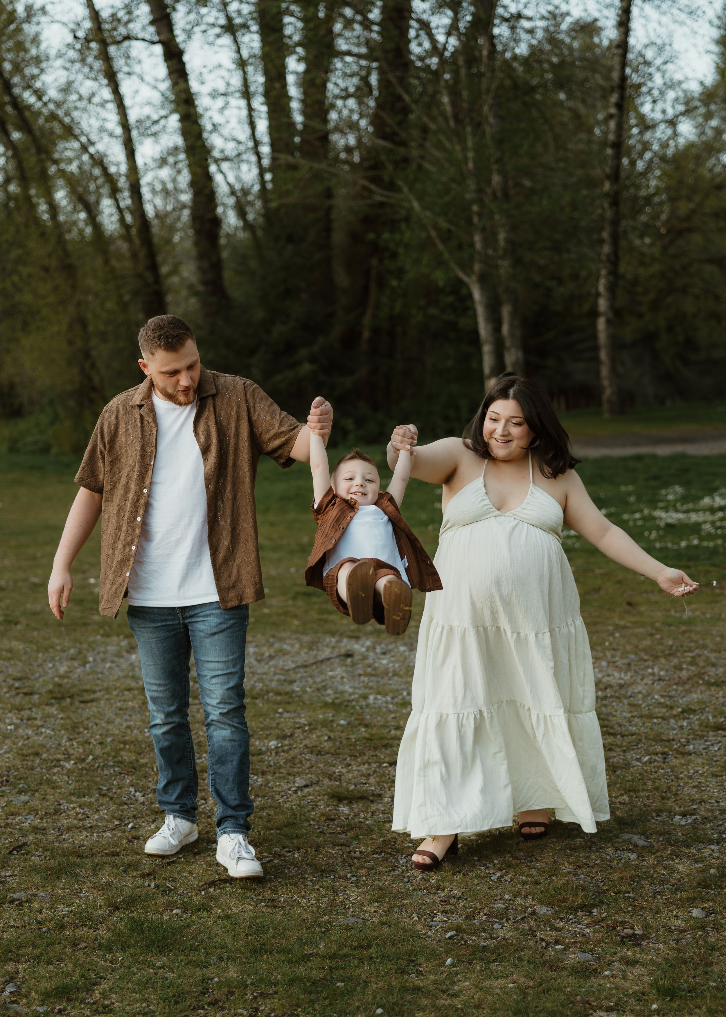 A playful family moment captured in a series of candid photos showing dancing and twirling in a park setting.
