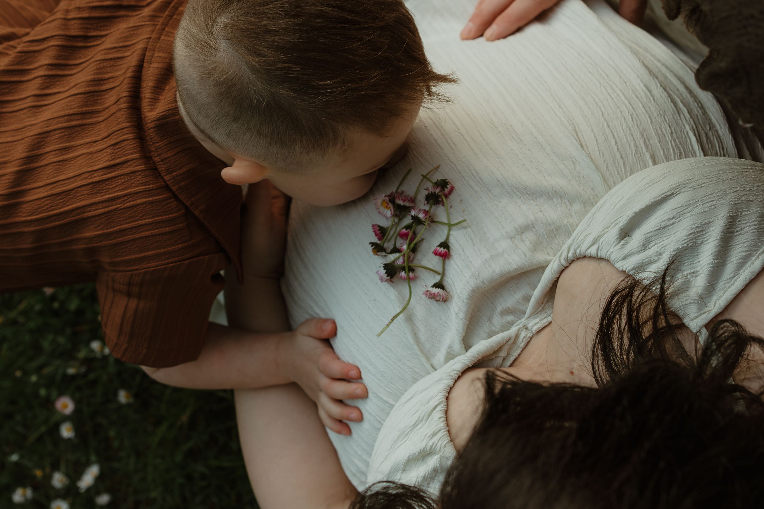 Close-up shots showing gentle interaction between parent and child in warm natural lighting.