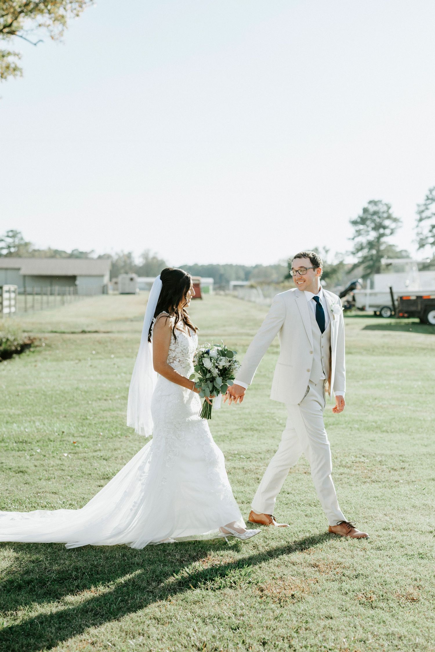 A bride and groom playfully run across a grassy field in a sequence of wedding photos.