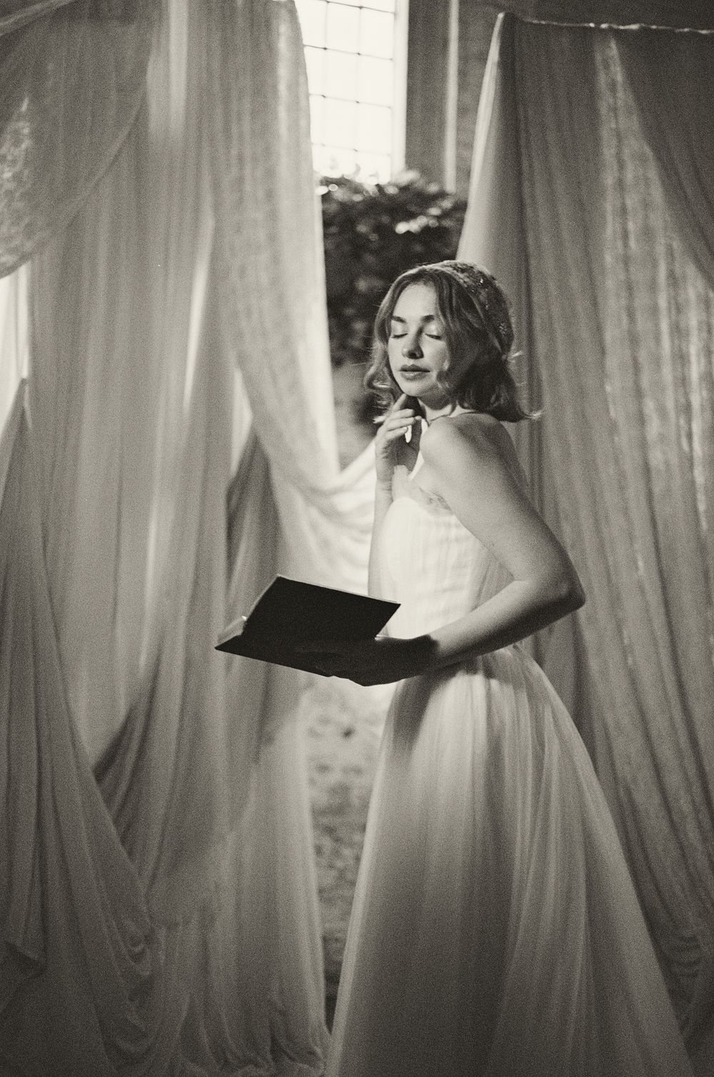 Artistic black and white triptych showing ethereal figures behind flowing white curtains in dramatic lighting.