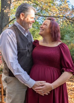 Couple sharing intimate moments during fall photo session outdoors.