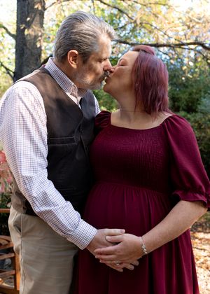 Romantic autumn photoshoot with a couple in burgundy and casual attire.