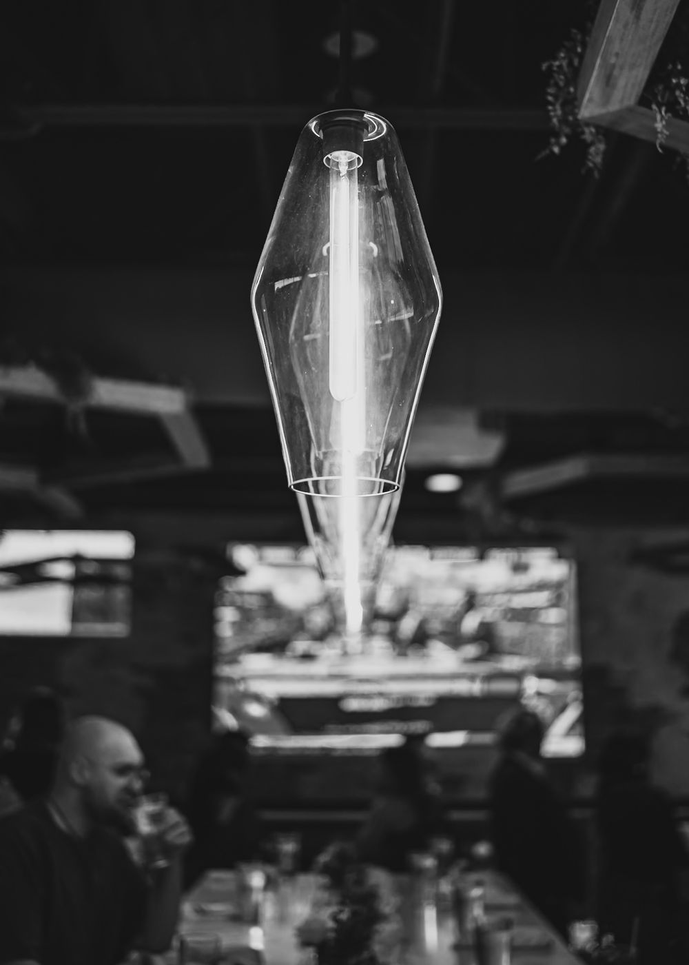 Modern pendant lights hanging from ceiling in black and white photography.
