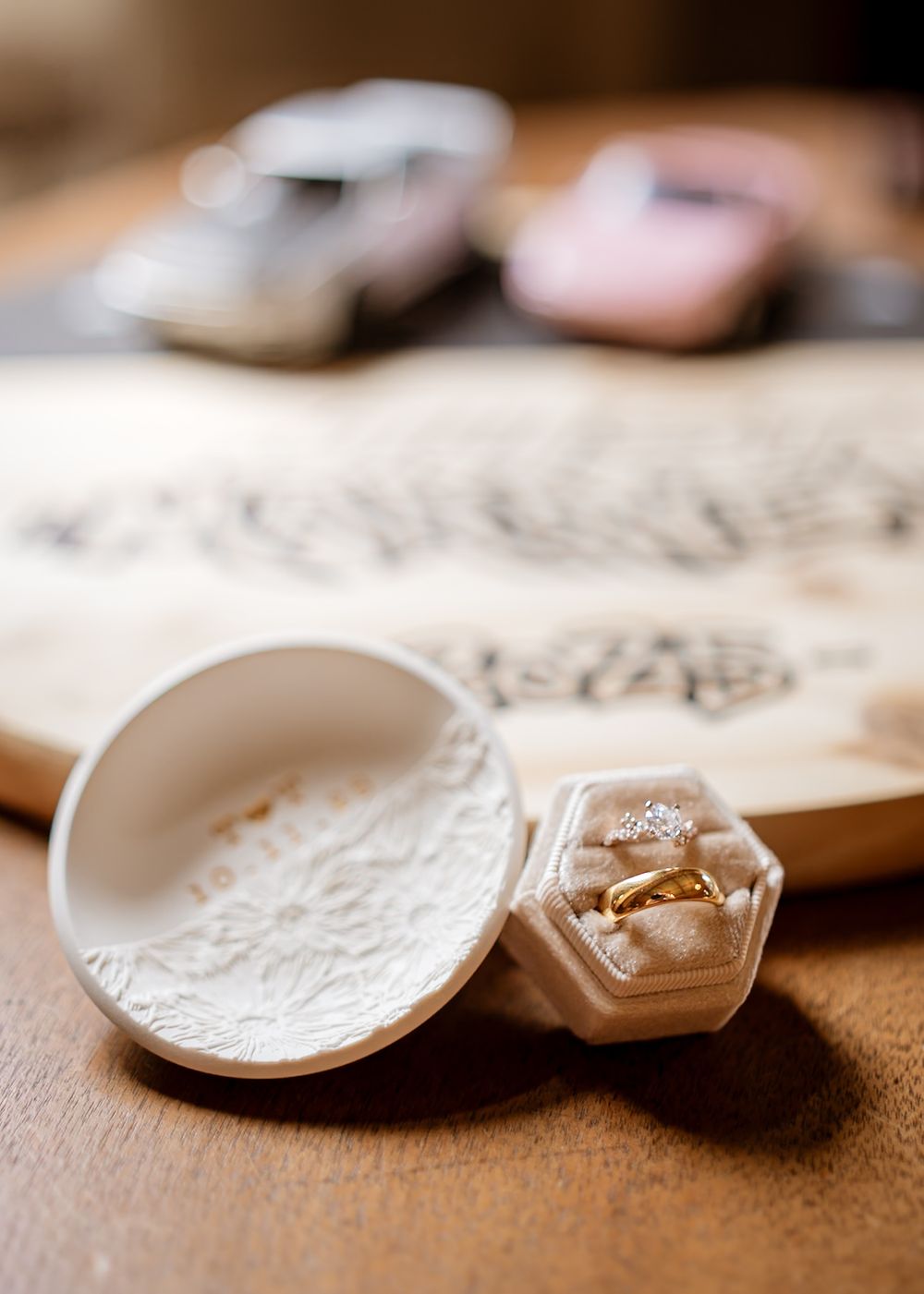 Close-up of broken white ceramic plates on a textured surface.