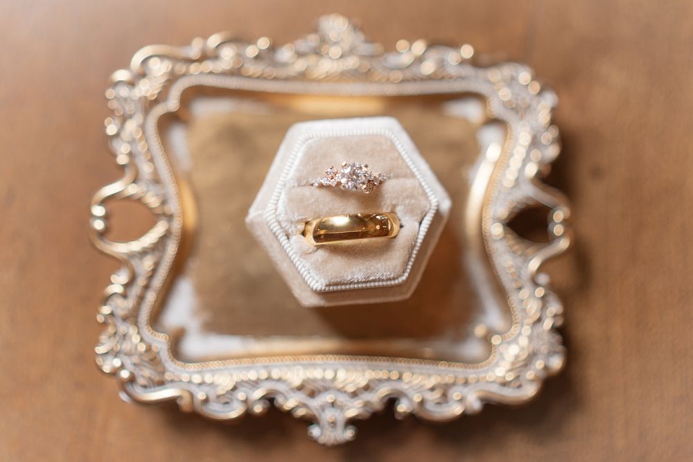 Ornate vintage silver frames with delicate details displayed on a beige background.