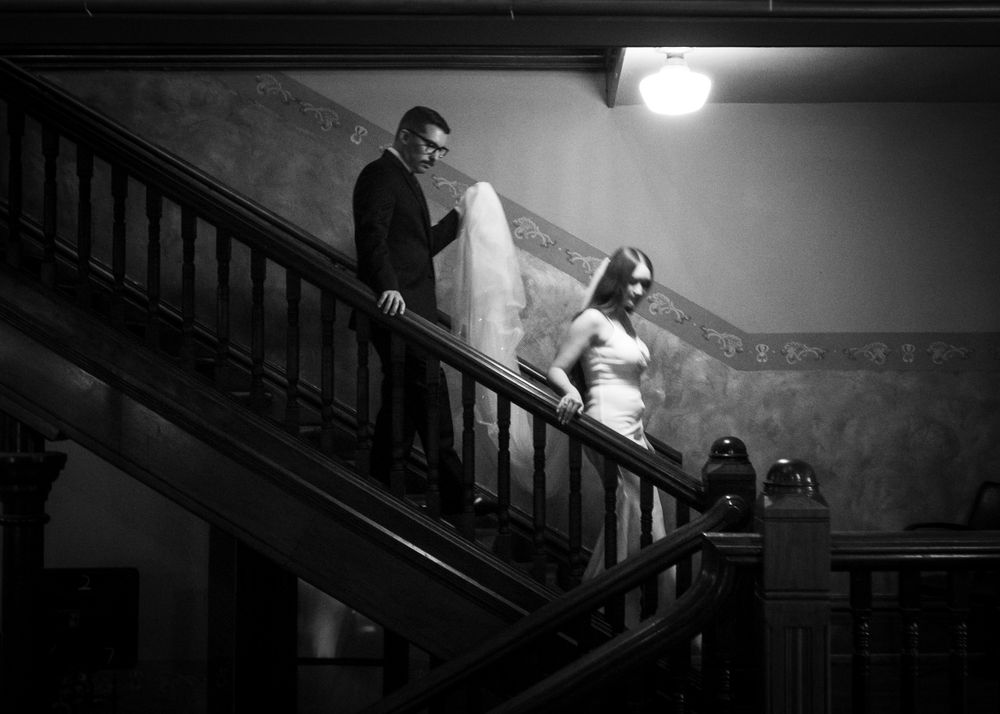 Dramatic black and white photo of a staircase in a wedding venue.