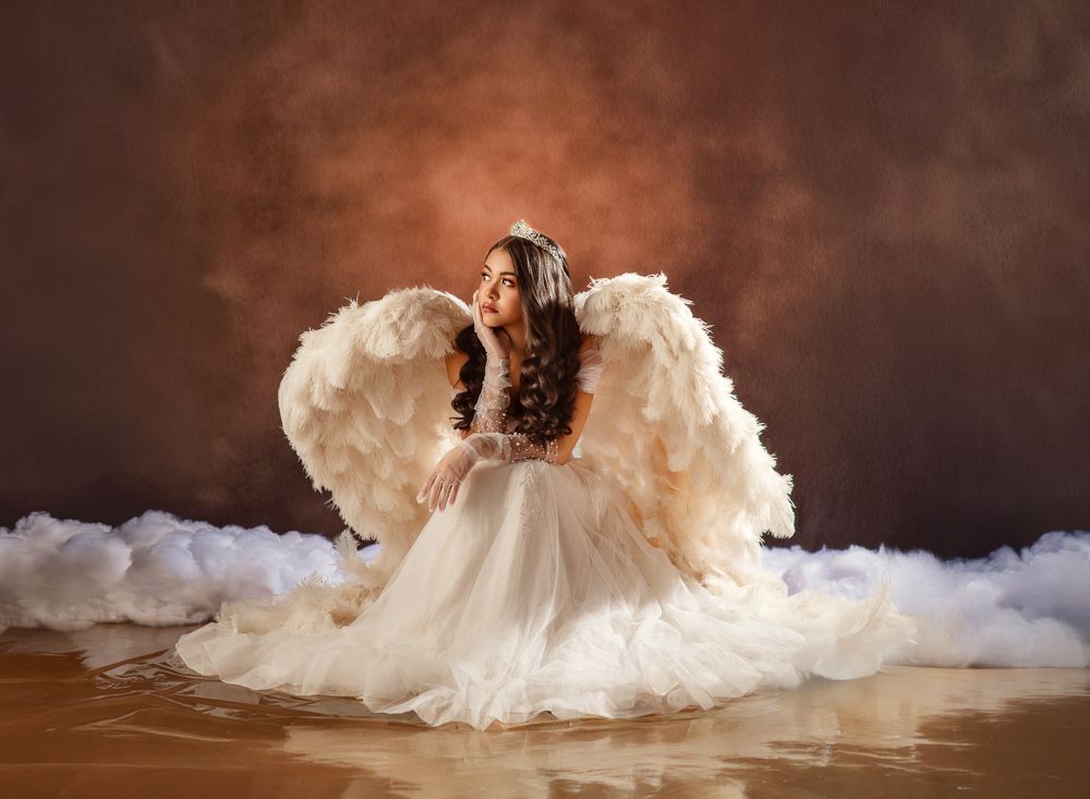 A ballet dancer in a white tutu dress performs a graceful spinning movement on a dark stage with dramatic lighting.