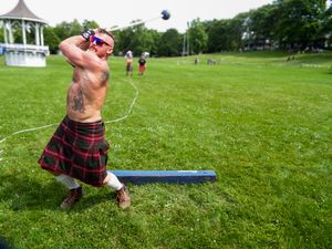 Athletes demonstrate traditional Scottish weight throwing techniques during Highland games competition.