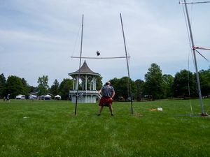 Competition field setup for Highland games with throwing areas and equipment visible.