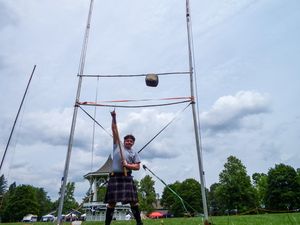 Highland games throwing equipment and poles set up against a bright blue sky.