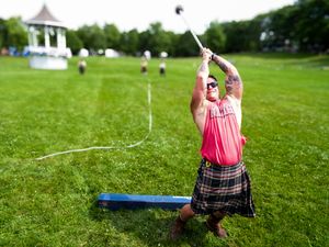 Athletes demonstrate traditional Scottish throwing techniques at outdoor highland games event.