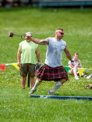 Competitors demonstrate various throwing positions during highland games festival.