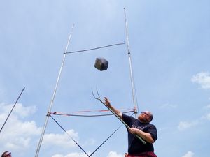 Multiple exposure shots of an athlete performing a weight throw at Highland Games.