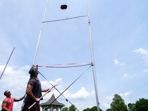 A weight soars through the air during a Highland Games throwing competition.
