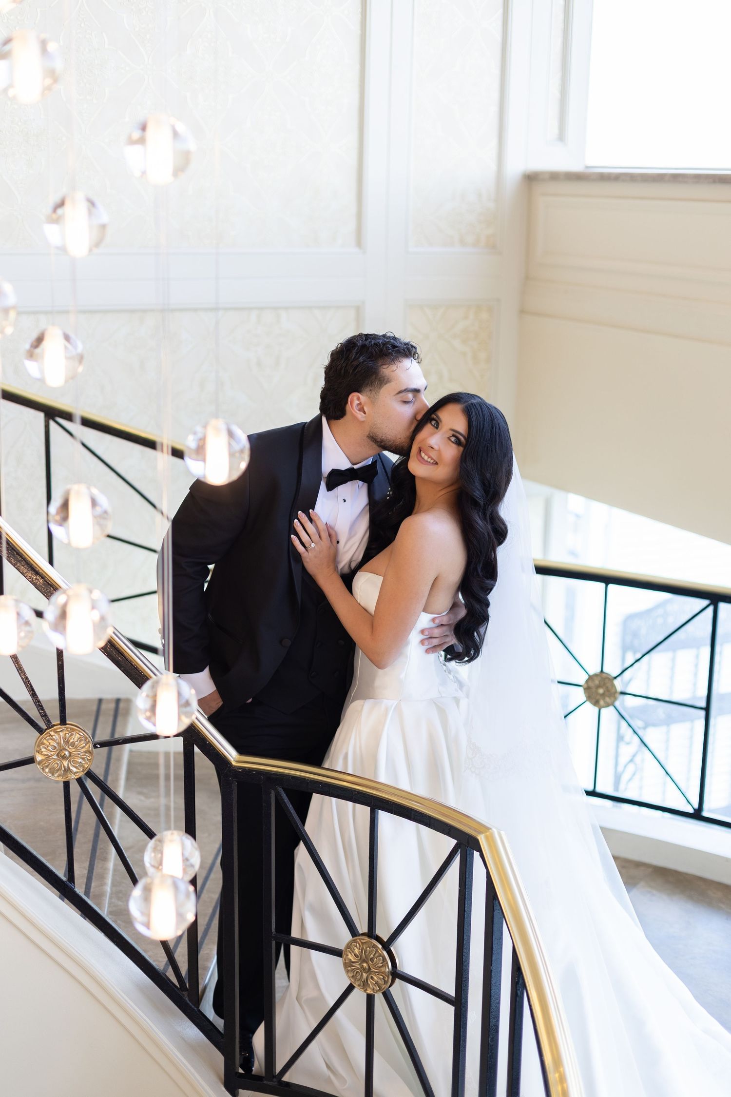Romantic wedding portrait of bride and groom on the grand staircase at Glen Island Harbour Club