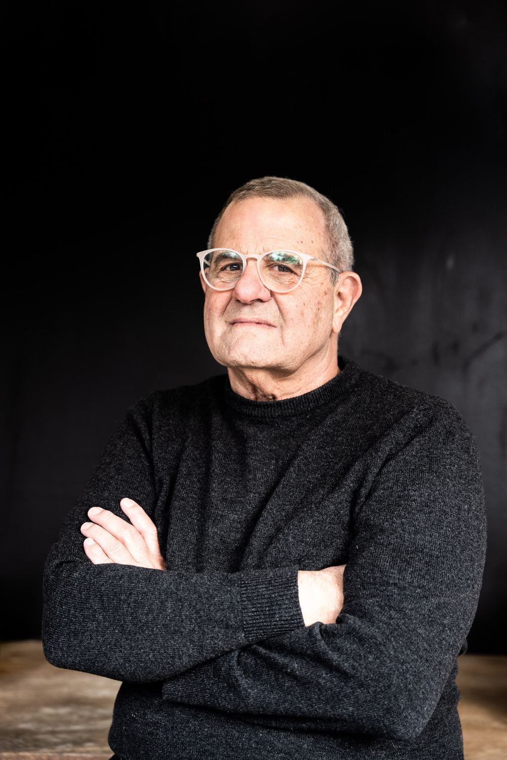 Classic black and white studio headshot of a man in a black turtleneck; high-end executive and artist portraits by a Florence specialist.