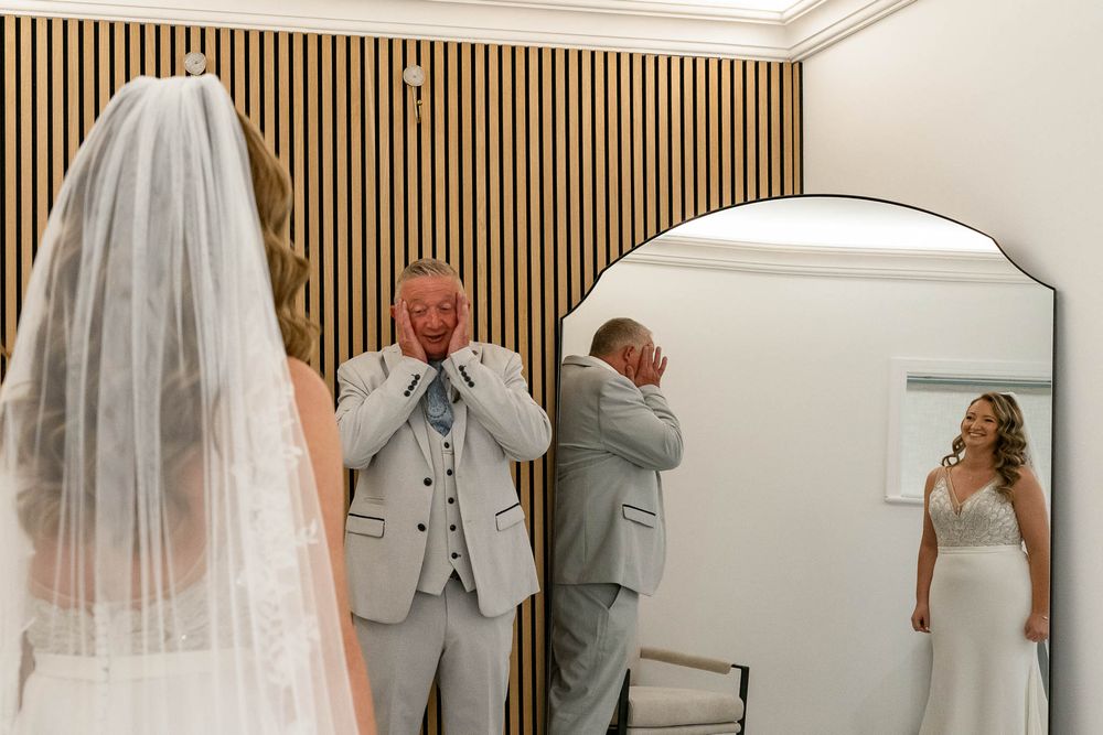 Wedding dress reveal to Bride's father at Watermouth Cove Weddings