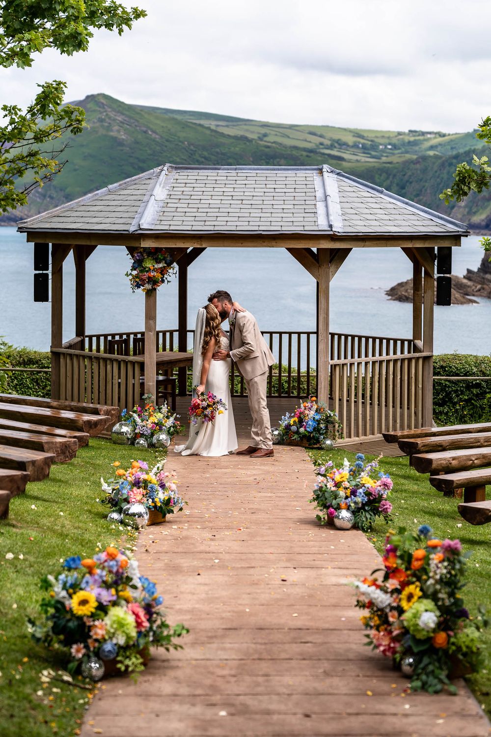 Bride and Groom by cremony area on cliff in North Devon Watermouth Cove Weddings