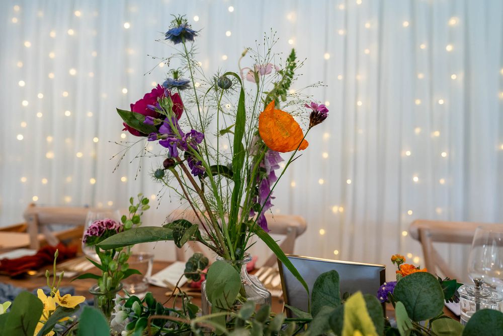 Flowers on table in reception room at Watermouth Cove Weddings