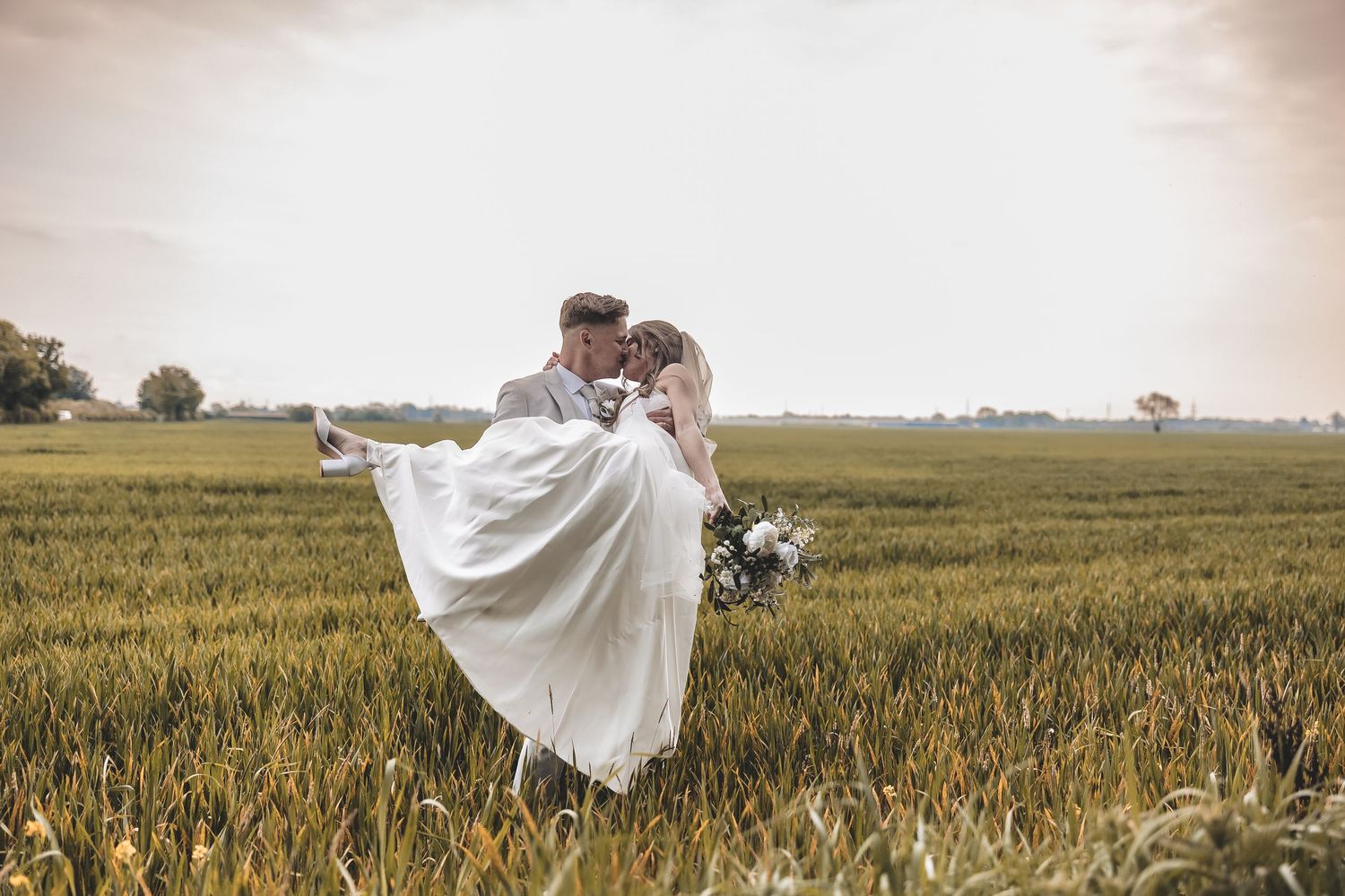 Guided couples portrait in a field at a Yorkshire wedding venue.