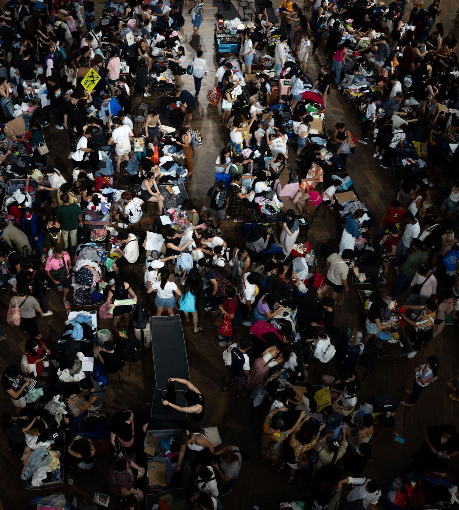 Large crowd of people gathered together in a densely packed outdoor space.