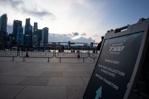 Modern city skyline with tall buildings and dramatic cloudy sky at dusk.