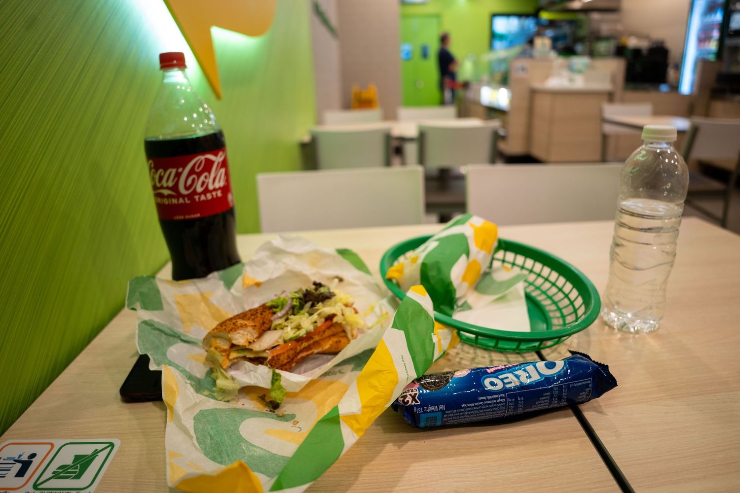 Fast food restaurant table with Coca-Cola drinks and snacks.