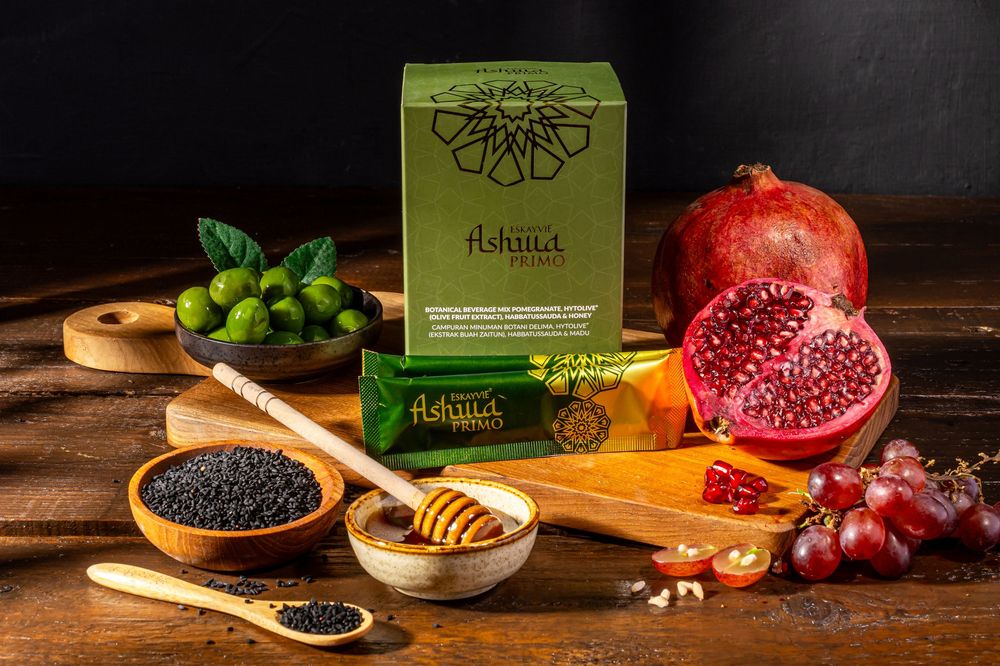 Natural food ingredients including pomegranate, honey, and dried fruits arranged on wooden surface.