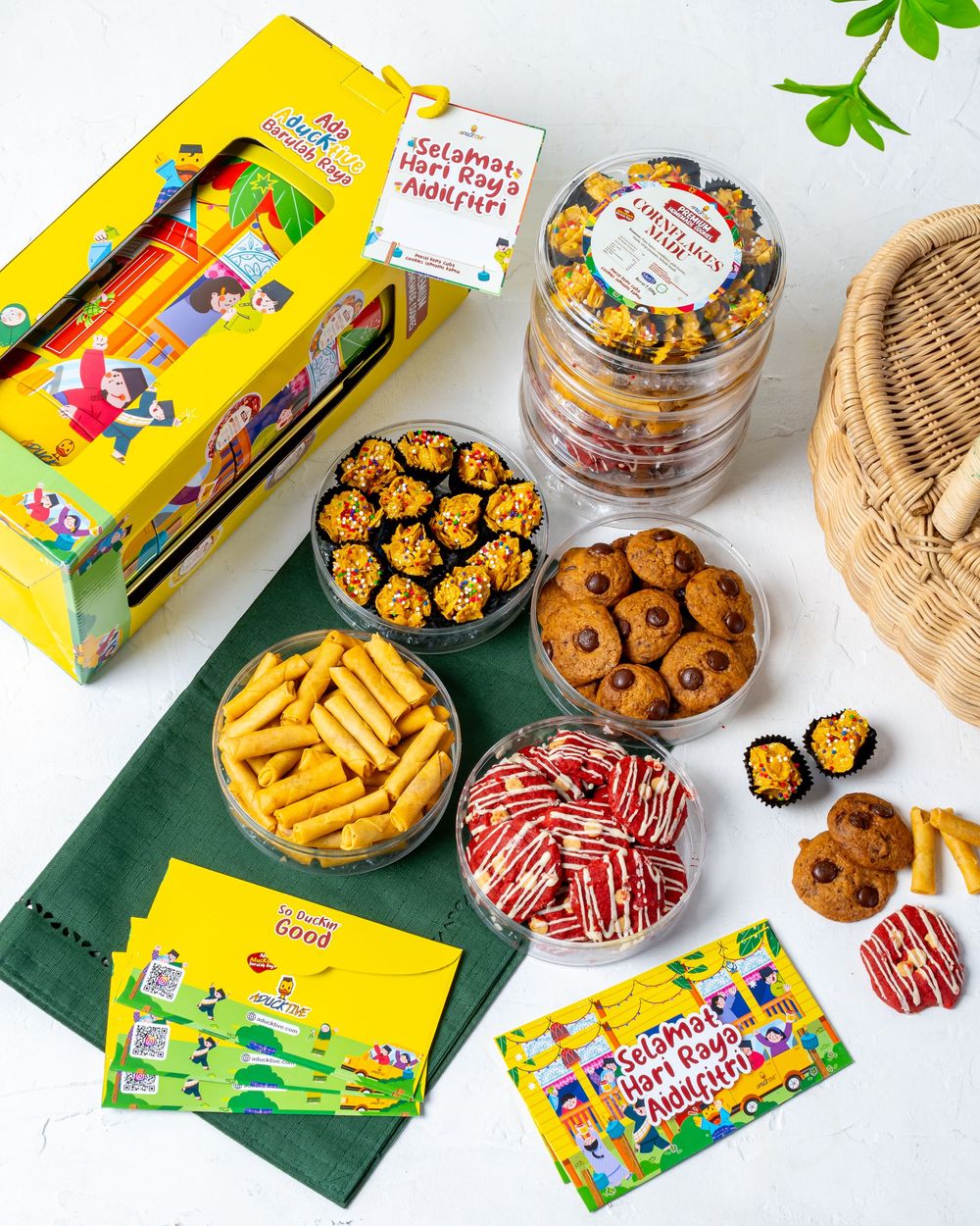 Colorful snack spread with chips, cookies, and candies arranged on green mat.