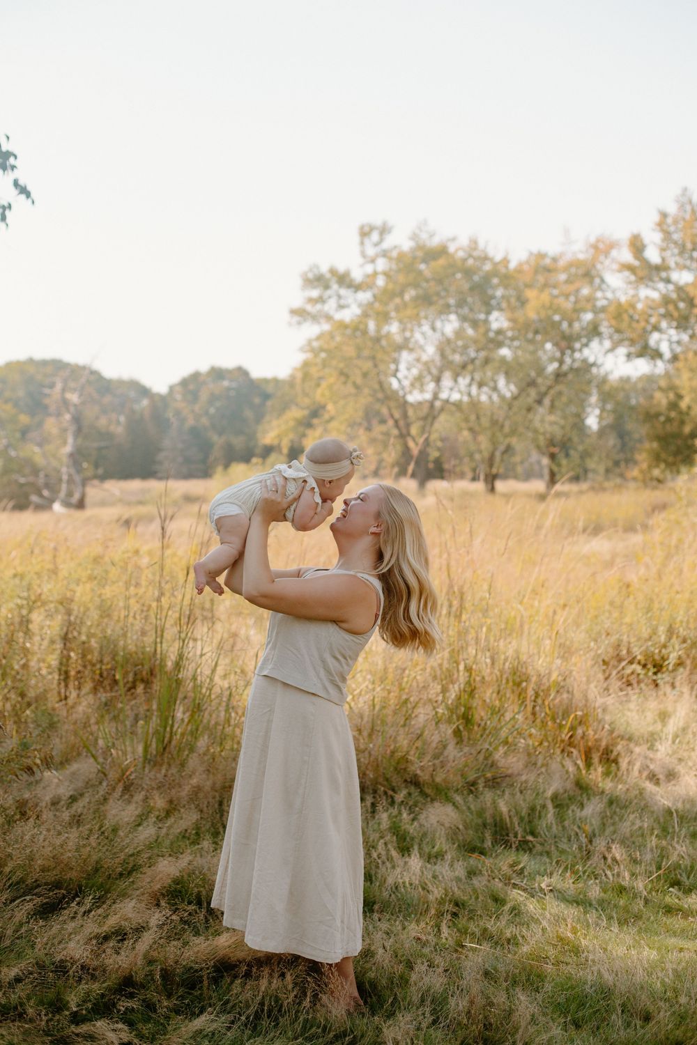Mom and baby in a golden field in Grand Rapids MI.