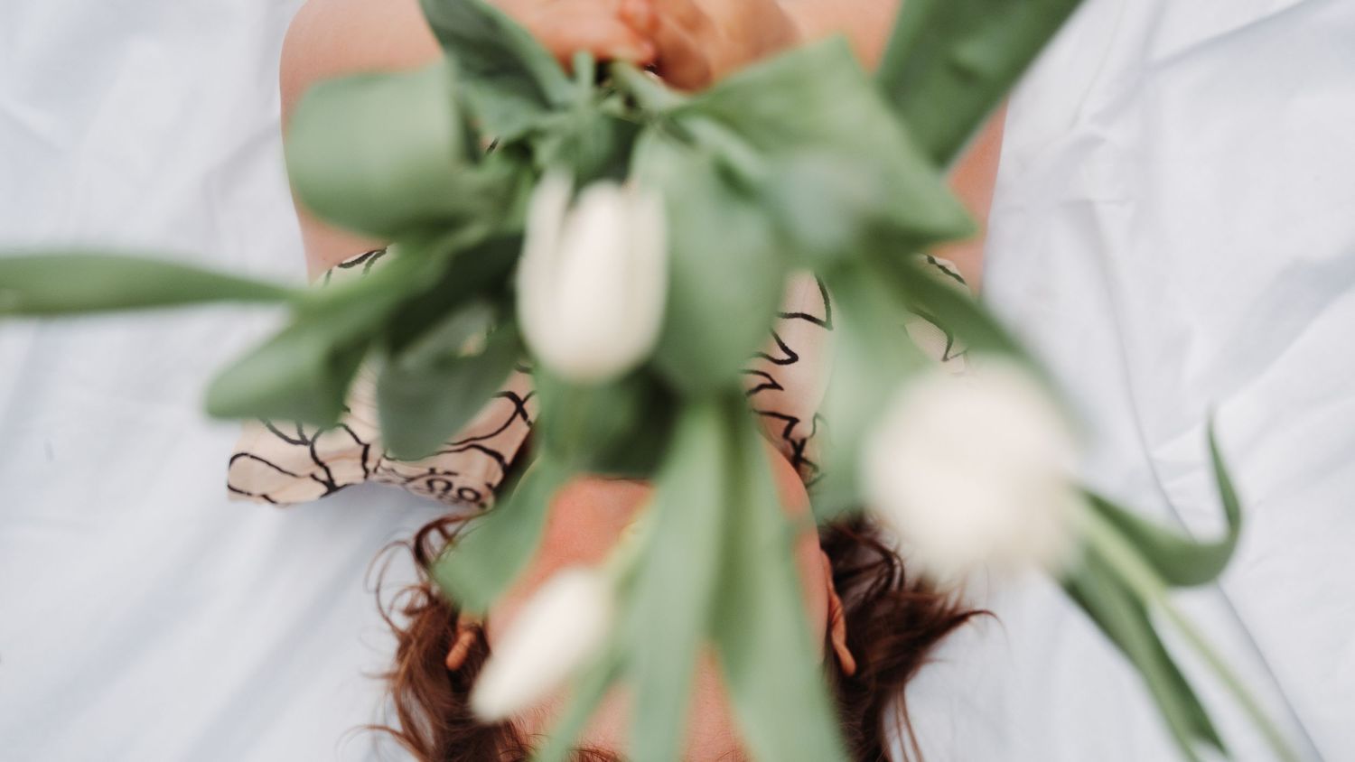 A decorative green bow tied with sage-colored ribbon against a white background.