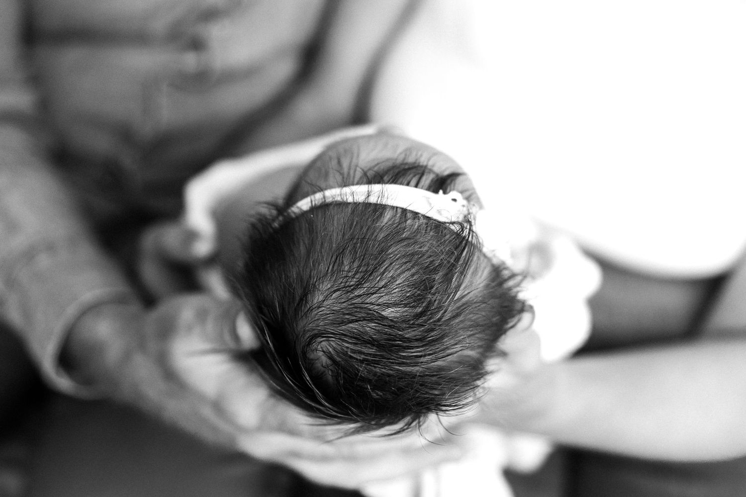 Honolulu Newborn Photographer captures a newborn baby girl's full head of hair.